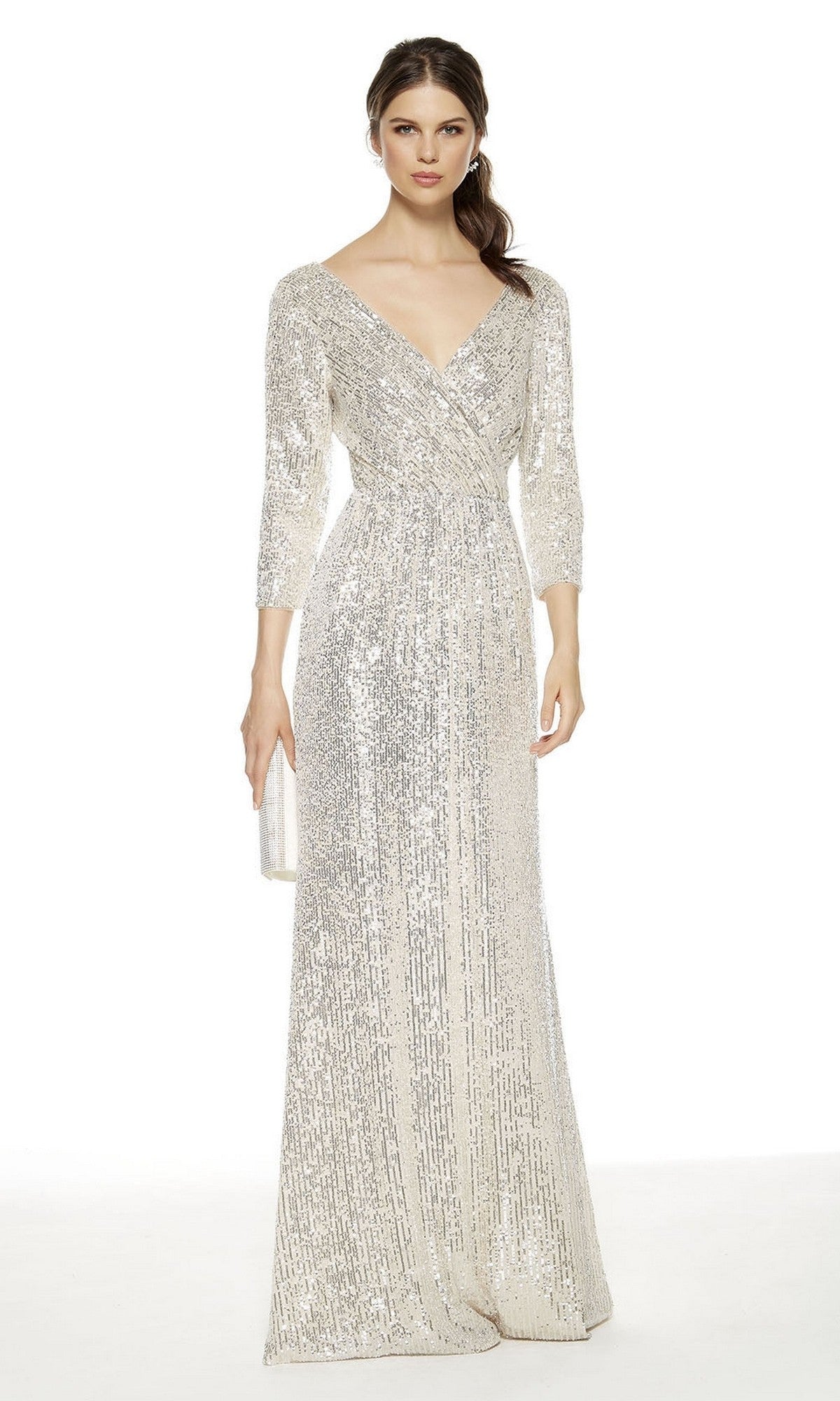 A woman in an Alyce 27358 long formal sand dress with three-quarter sleeves and sequins holds a matching clutch against a white background—an elegant mother-of-the-bride choice.